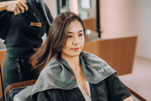 woman getting hair blow-dried at PHS HAIRSCIENCE