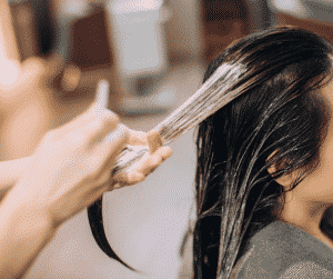 Young woman getting silicone-free hair treatment