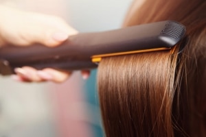 Styling hair with a straightening iron