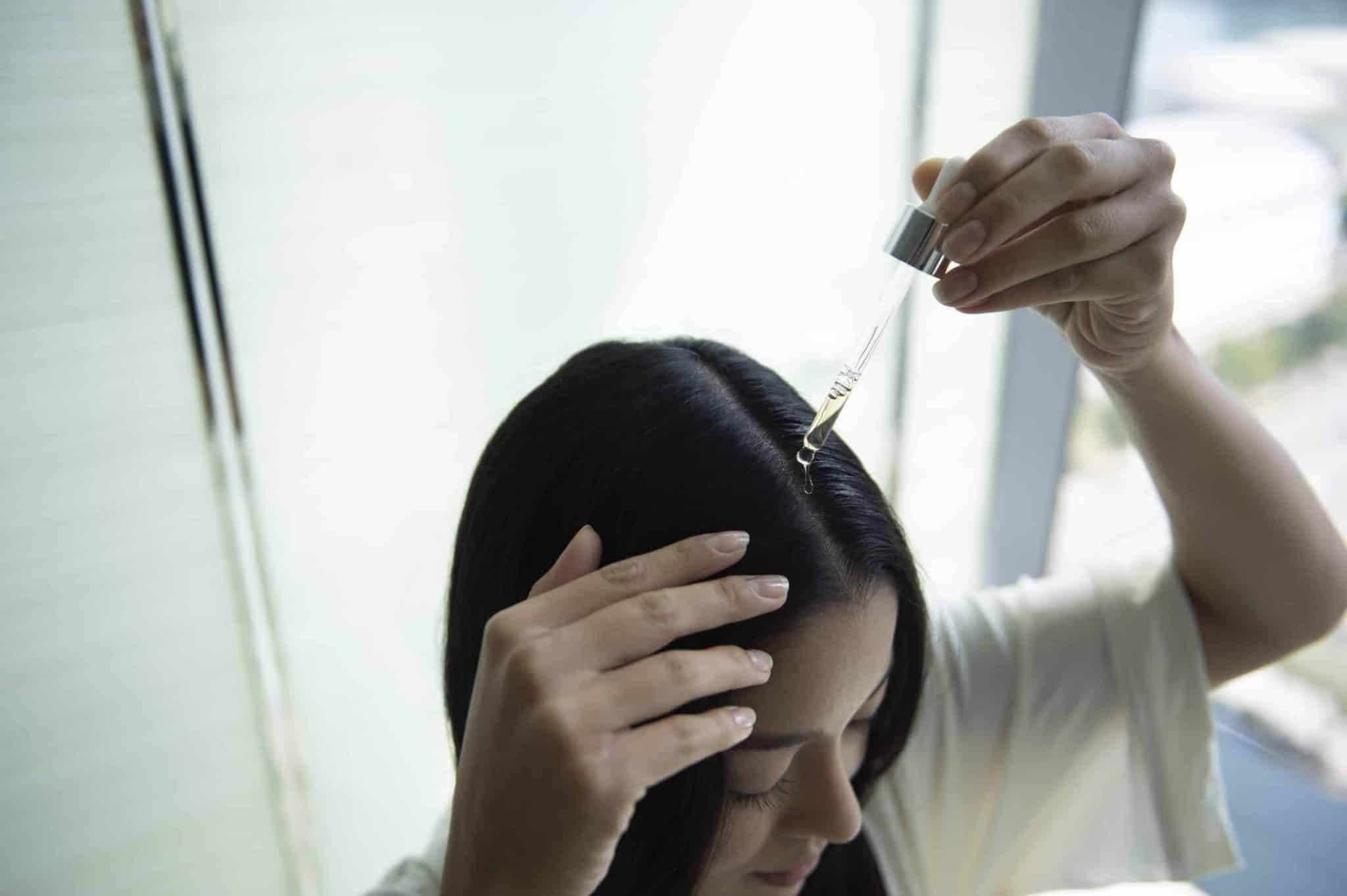 woman-applying-phs-hairscience-scalp-primer
