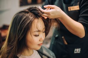 Woman having hair treatment in PHS HAIRSCIENCE outlet