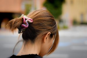 woman wearing a colourful scrunchie in her hair